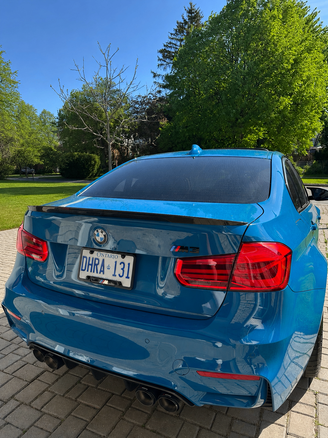 Rear of the Laguna Seca Blue M3 with carbon trunk spoiler and quad exhaust